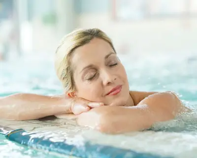 Middle-aged woman enjoying thermal bath in thalassotherapy center